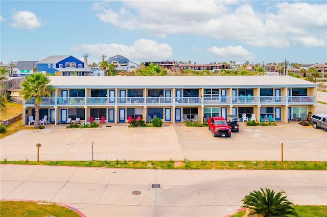 view of building exterior with uncovered parking