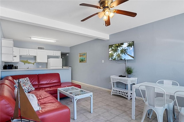 living area featuring visible vents, light tile patterned flooring, ceiling fan, beamed ceiling, and baseboards