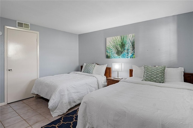 bedroom with light tile patterned floors and visible vents