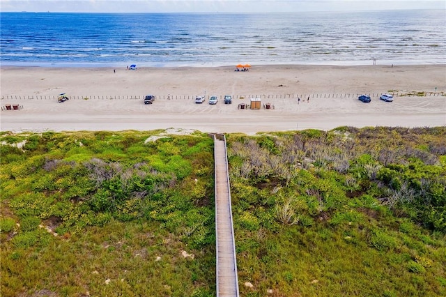 drone / aerial view featuring a water view and a beach view