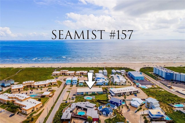 bird's eye view with a water view and a beach view