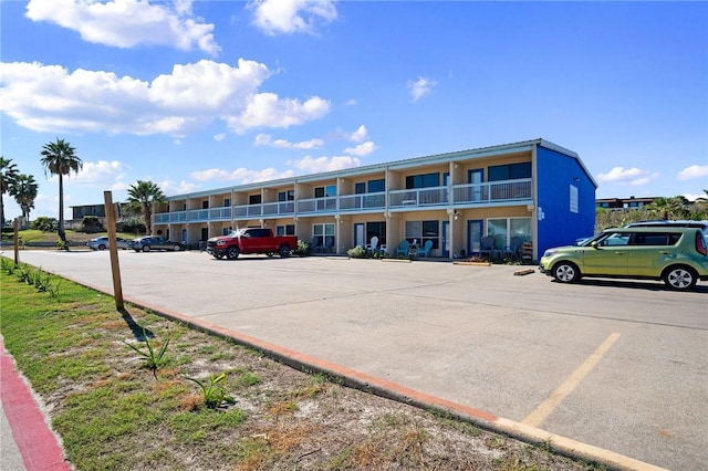 view of building exterior with uncovered parking