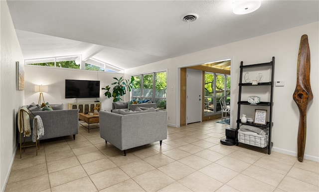 living room featuring lofted ceiling with beams and light tile patterned floors