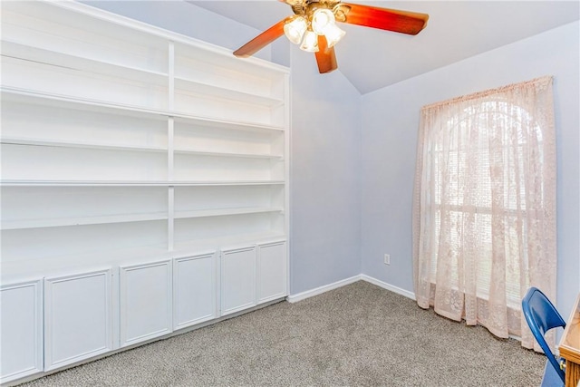 spare room with lofted ceiling, light carpet, and ceiling fan