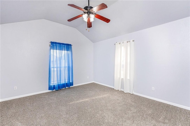 carpeted spare room with ceiling fan and lofted ceiling