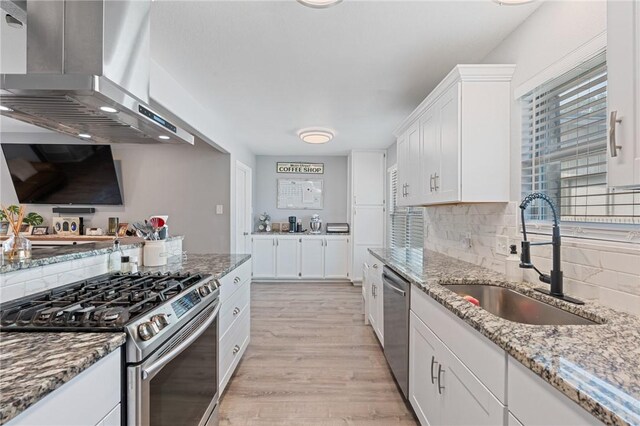 116 Daniel Moore St, Portland, TX 78374 - kitchen with stainless steel appliances, extractor fan, a sink, light wood-type flooring, and white cabinetry