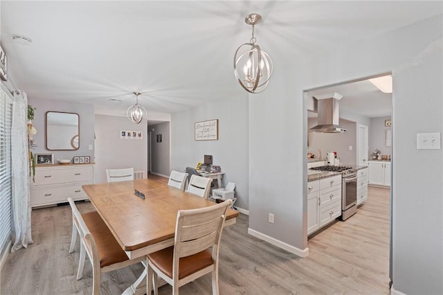 116 Daniel Moore St, Portland, TX 78374 - dining space featuring a chandelier, light wood finished floors, and baseboards