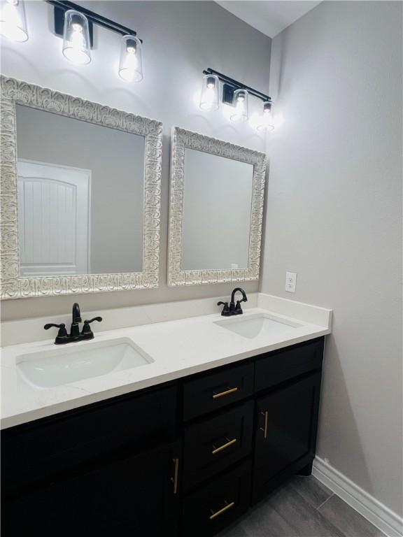 7722 Nadia Dr, Corpus Christi, TX 78414 - bathroom with double vanity and baseboards