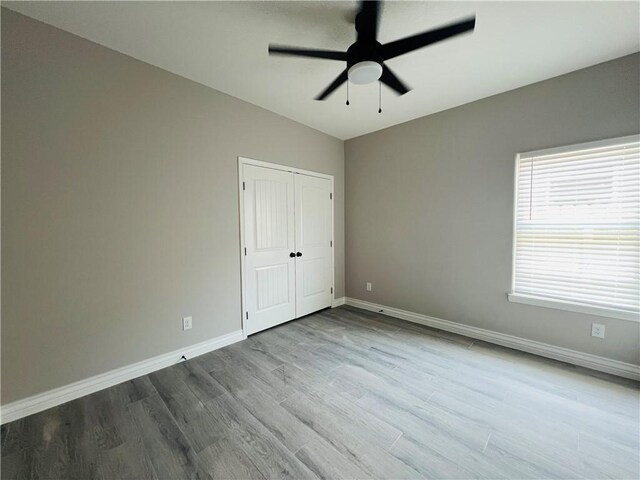 7722 Nadia Dr, Corpus Christi, TX 78414 - unfurnished bedroom with baseboards, wood finished floors, a closet, and a ceiling fan