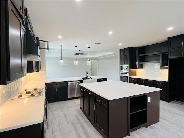 7722 Nadia Dr, Corpus Christi, TX 78414 - kitchen with appliances with stainless steel finishes, dark cabinets, a center island, open shelves, and recessed lighting