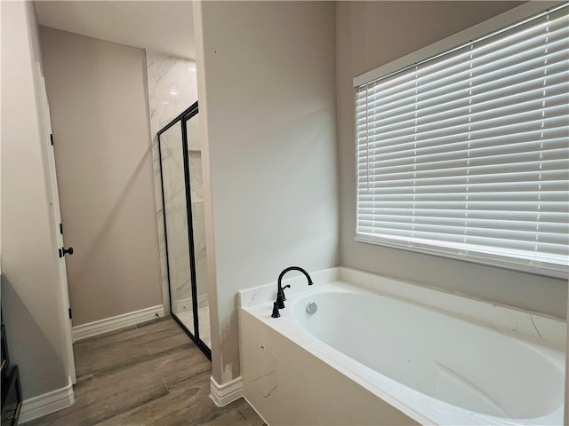 7722 Nadia Dr, Corpus Christi, TX 78414 - full bath with a garden tub, wood finished floors, a shower stall, and baseboards