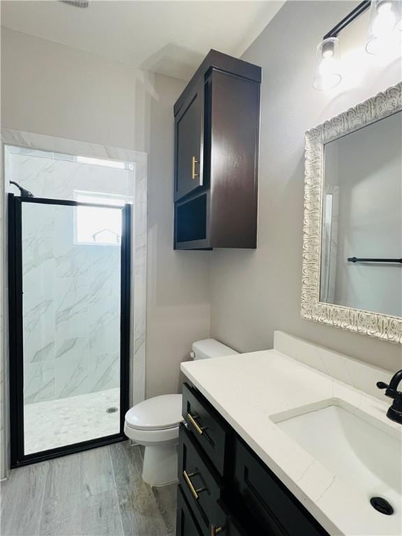 7722 Nadia Dr, Corpus Christi, TX 78414 - full bathroom featuring vanity, toilet, a marble finish shower, and wood finished floors
