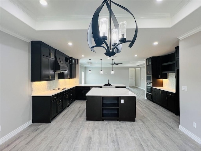 7722 Nadia Dr, Corpus Christi, TX 78414 - kitchen featuring a raised ceiling, dark cabinetry, oven, recessed lighting, and crown molding