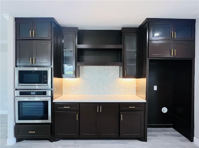 7722 Nadia Dr, Corpus Christi, TX 78414 - kitchen featuring oven, built in microwave, light countertops, and tasteful backsplash