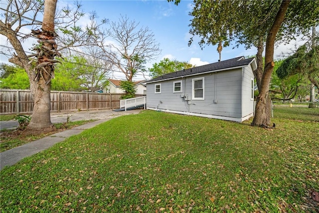 back of house with a lawn and fence private yard