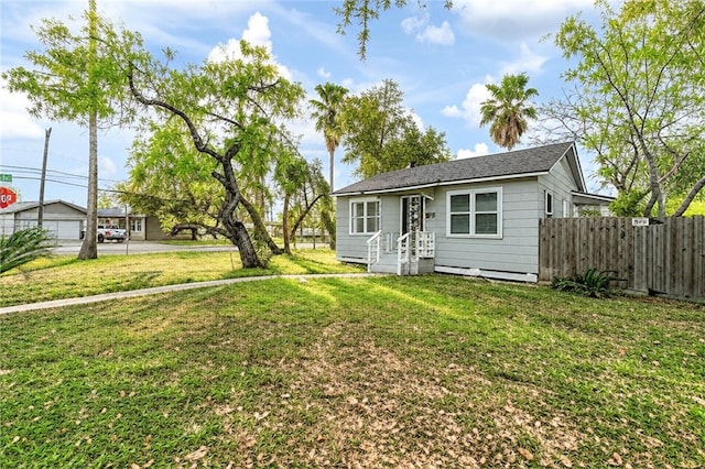 bungalow with fence and a front yard