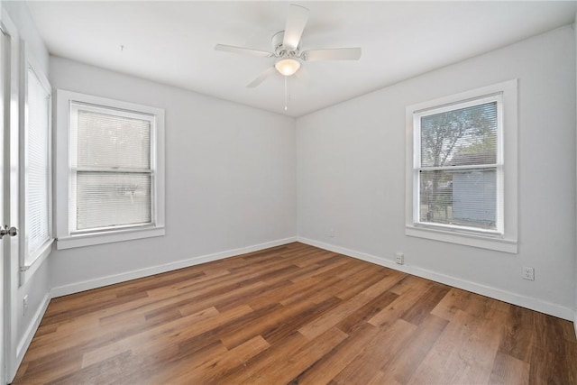 unfurnished room featuring baseboards, a ceiling fan, and wood finished floors