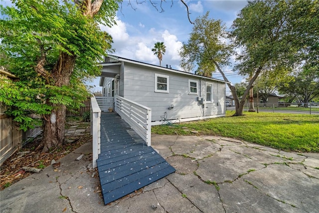 back of property with a fenced backyard, a patio, and a lawn