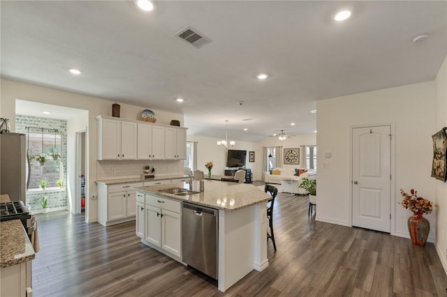 kitchen featuring a sink, visible vents, white cabinetry, freestanding refrigerator, and dishwasher