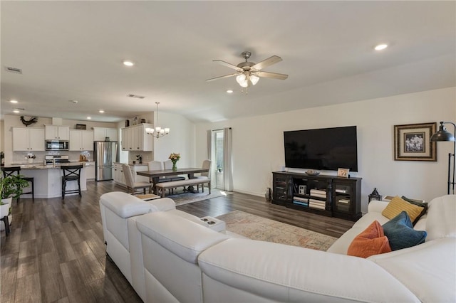 living area featuring visible vents, dark wood-type flooring, and recessed lighting