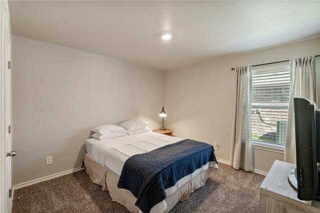 bedroom featuring carpet floors and baseboards