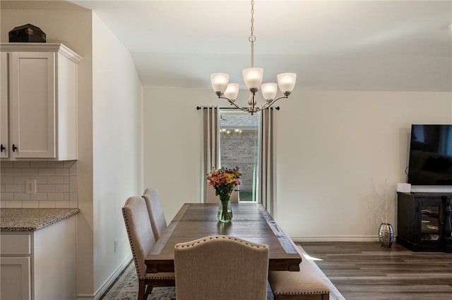 dining room with baseboards, dark wood-style flooring, and an inviting chandelier