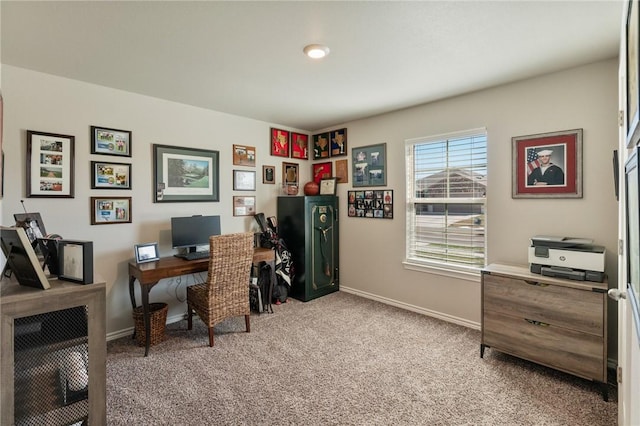 home office with baseboards and light colored carpet