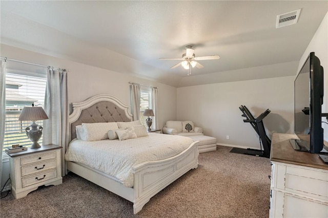 carpeted bedroom featuring a ceiling fan, visible vents, and baseboards