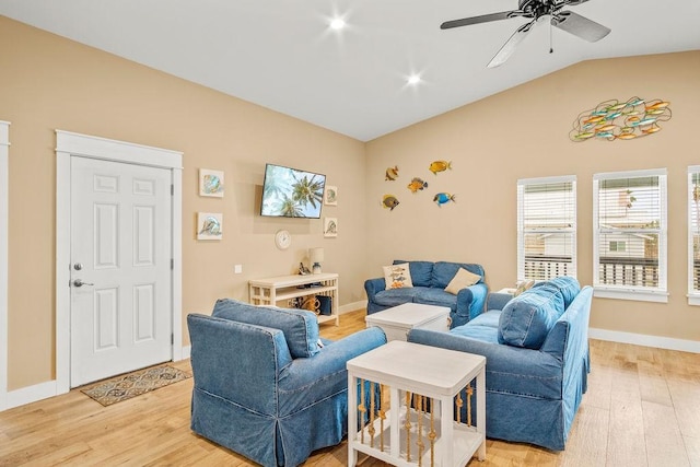 living room featuring light wood-style flooring, ceiling fan, vaulted ceiling, and baseboards
