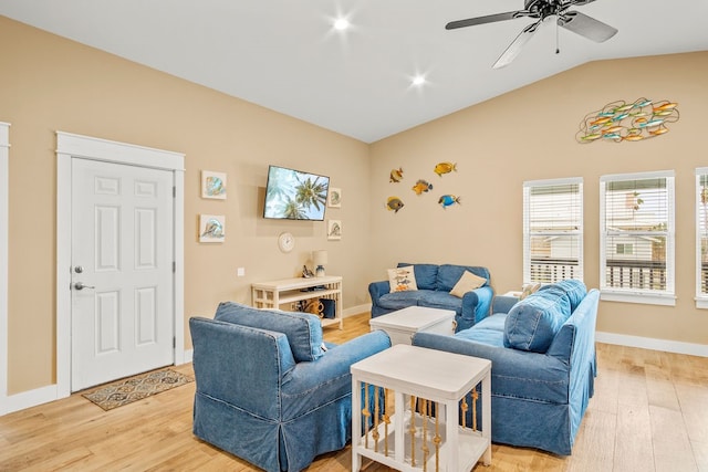 living room featuring light hardwood / wood-style floors, ceiling fan, and vaulted ceiling