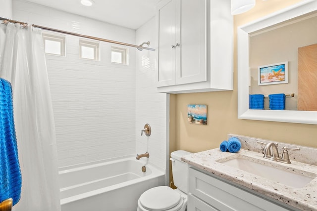 full bathroom featuring shower / bath combo, vanity, and toilet