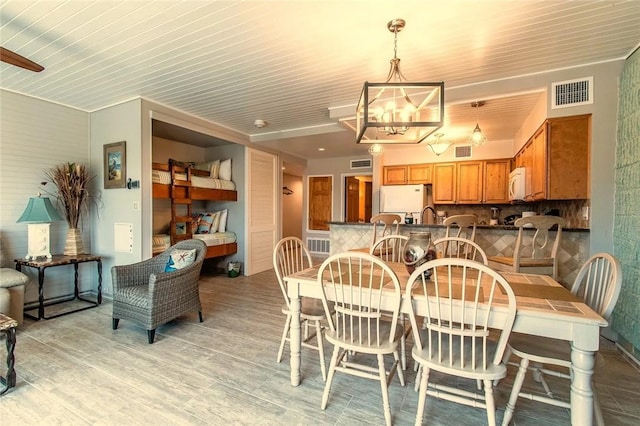 7477 State Highway 361 Unit 107, Port Aransas, TX 78373 - dining space with light wood-style floors and a chandelier
