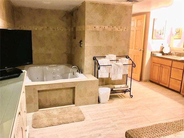 7477 State Highway 361 Unit 107, Port Aransas, TX 78373 - full bathroom featuring a tub with jets, vanity, tile walls, tiled shower, and tile patterned floors