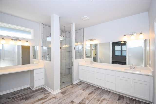 3002 N Oso Pkwy, Corpus Christi, TX 78414 - bathroom with a shower stall, double vanity, wood finished floors, and baseboards