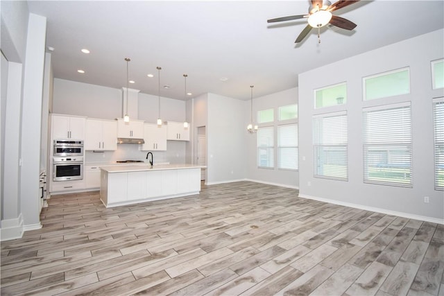 3002 N Oso Pkwy, Corpus Christi, TX 78414 - kitchen featuring double oven, open floor plan, light wood-style flooring, and recessed lighting
