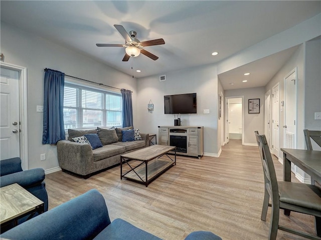 living room featuring ceiling fan and light wood-type flooring