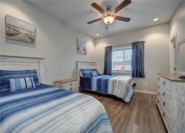 bedroom with dark hardwood / wood-style floors and ceiling fan