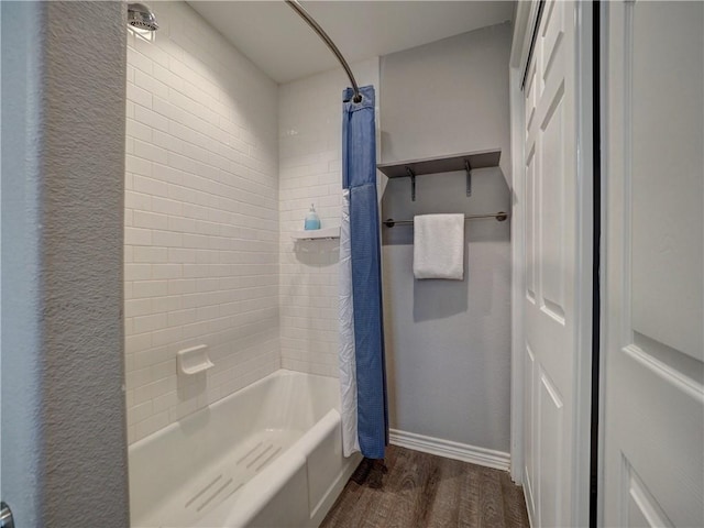 bathroom with wood-type flooring and shower / tub combo with curtain