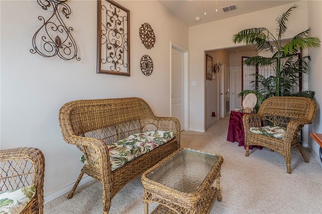 sitting room featuring light colored carpet