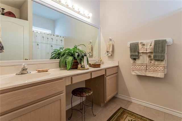 bathroom with tile patterned floors, vanity, and walk in shower