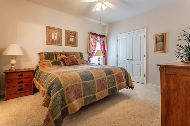 carpeted bedroom with a closet and ceiling fan