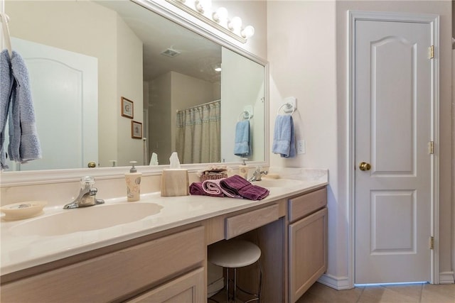 bathroom featuring tile patterned flooring, vanity, and walk in shower