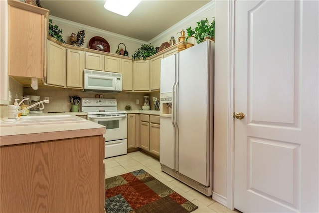 kitchen with white appliances, sink, light tile patterned floors, and ornamental molding