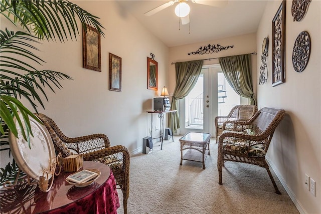 living area featuring french doors, light colored carpet, and ceiling fan