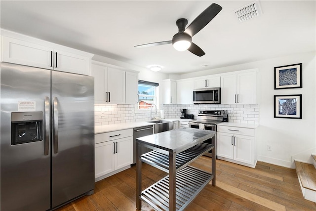 500 Royal Palm Ln, Port Aransas, TX 78373 - kitchen with stainless steel appliances, a sink, decorative backsplash, and light countertops