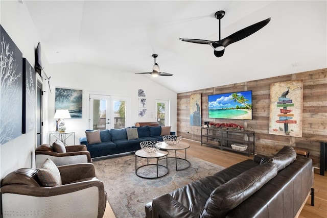 500 Royal Palm Ln, Port Aransas, TX 78373 - living area featuring wooden walls, wood finished floors, lofted ceiling, a ceiling fan, and french doors