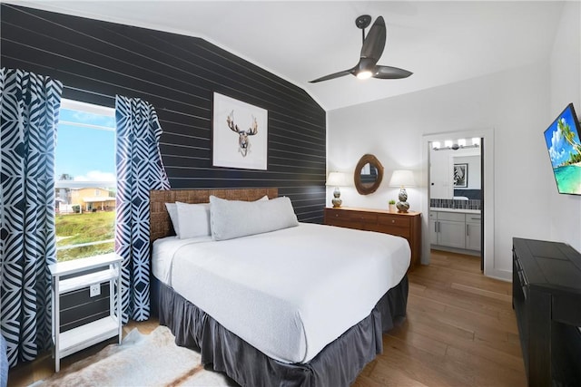 500 Royal Palm Ln, Port Aransas, TX 78373 - bedroom with multiple windows, lofted ceiling, wood finished floors, a ceiling fan, and connected bathroom