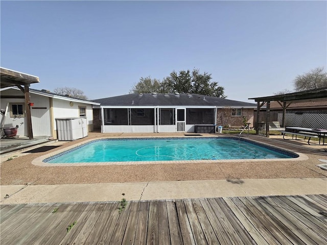 view of swimming pool featuring a patio, fence, a sunroom, and a fenced in pool