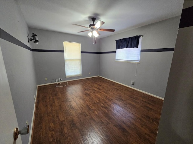 unfurnished room featuring ceiling fan, baseboards, and wood finished floors