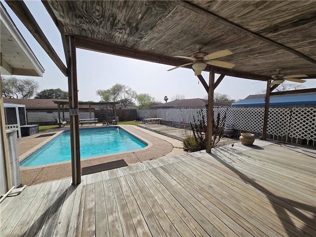 view of pool with a fenced in pool, ceiling fan, a fenced backyard, a deck, and a patio area